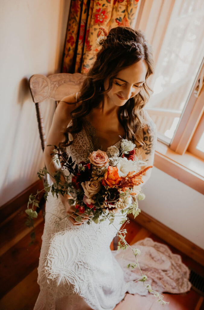 Miranda on her wedding day holding a bouquet in warm autumn tones, reflecting a brand colour palette that finally felt like home.