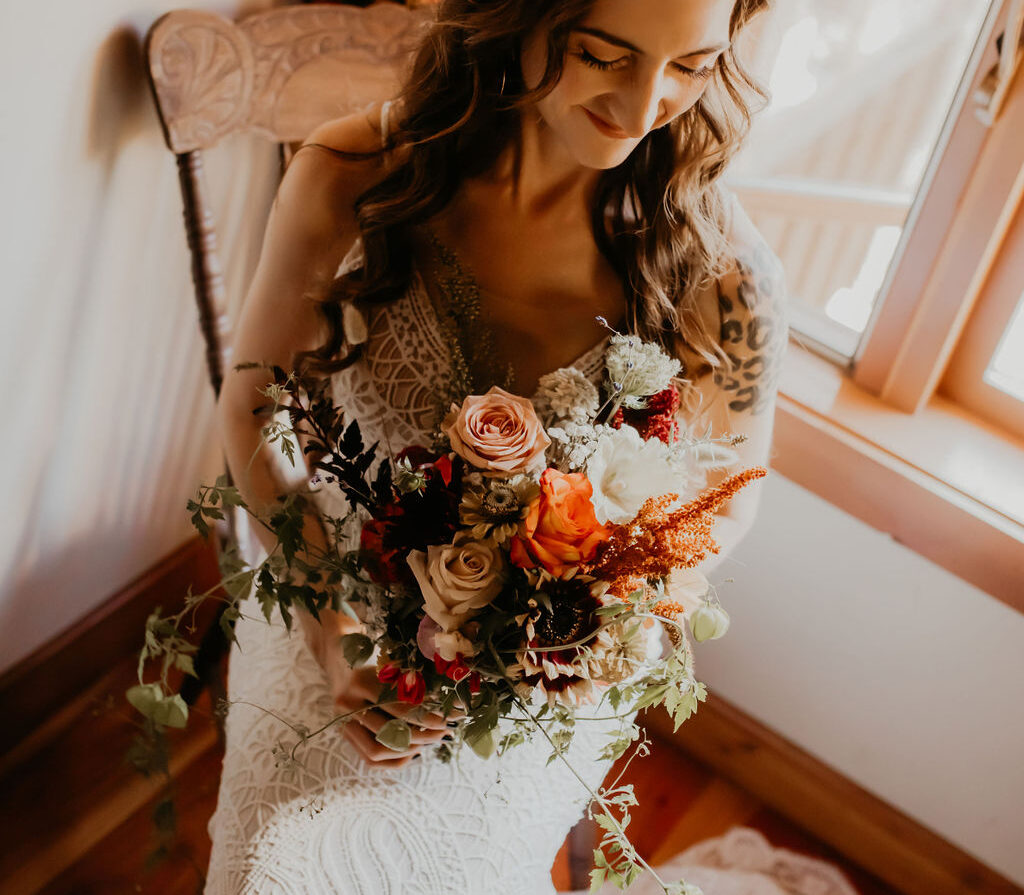 Miranda on her wedding day holding a bouquet in warm autumn tones, reflecting a brand colour palette that finally felt like home.